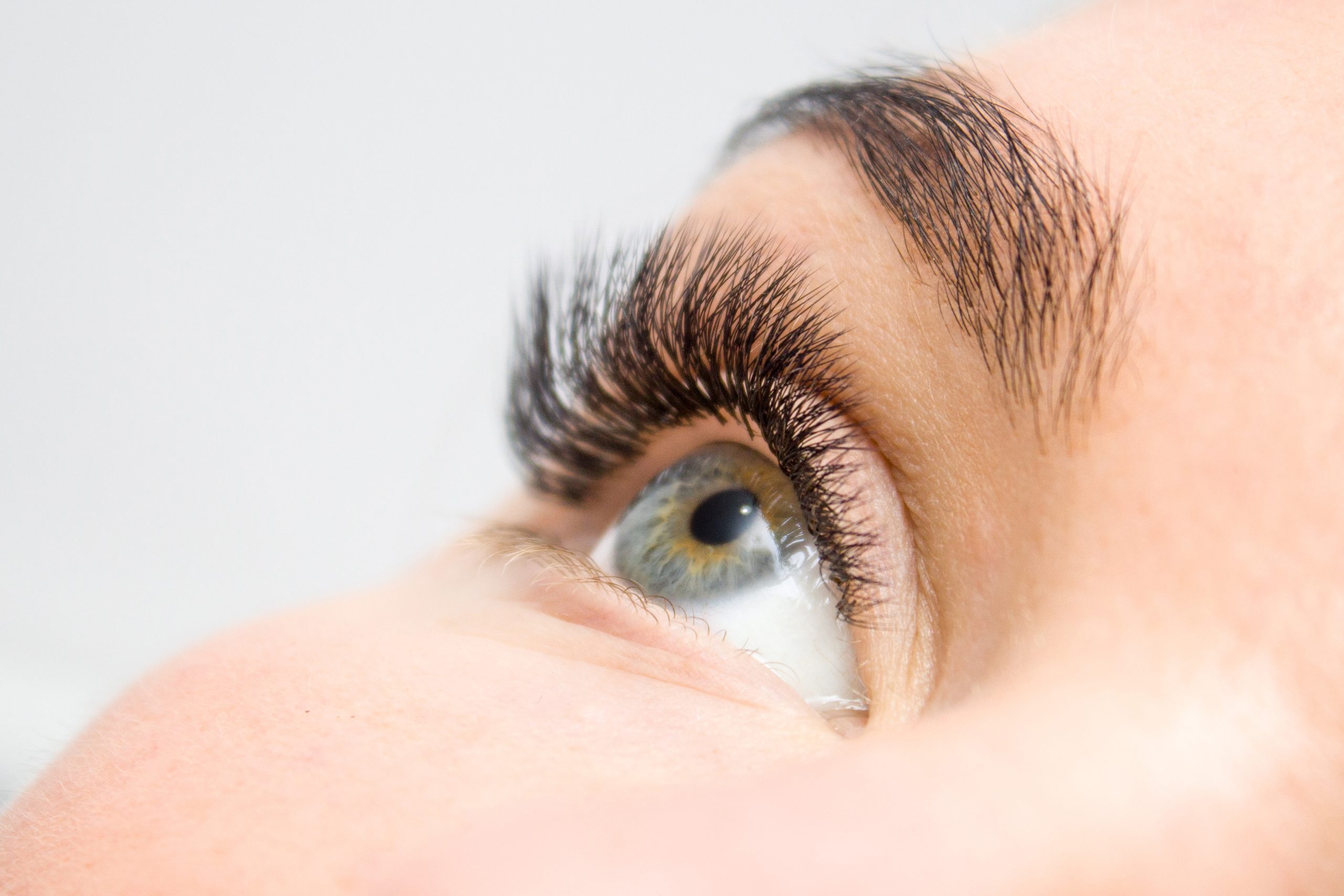 Beautiful Woman with long lashes in a beauty salon. Eyelash extension.