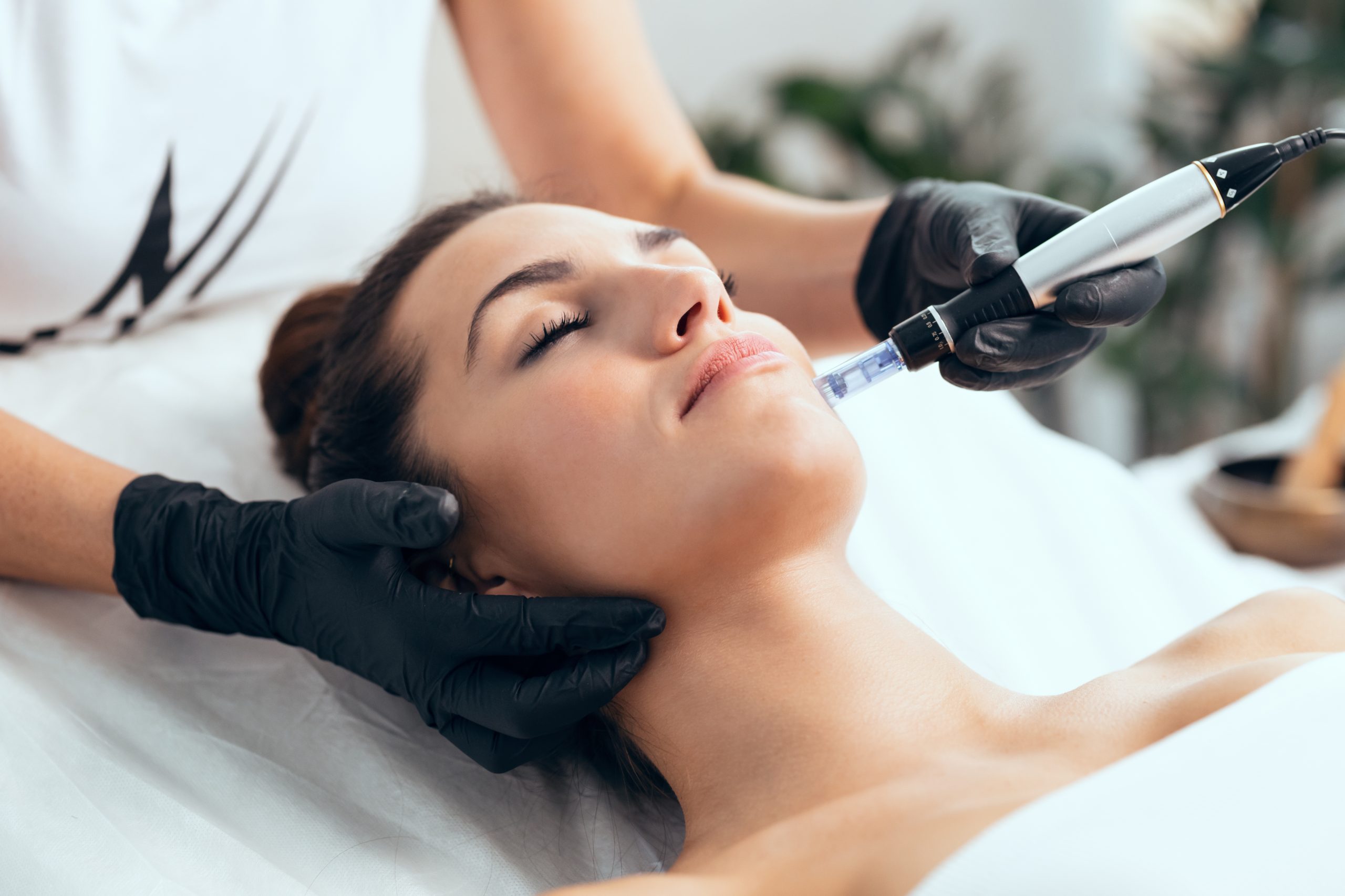 Cosmetologist making mesotherapy injection with dermapen on face